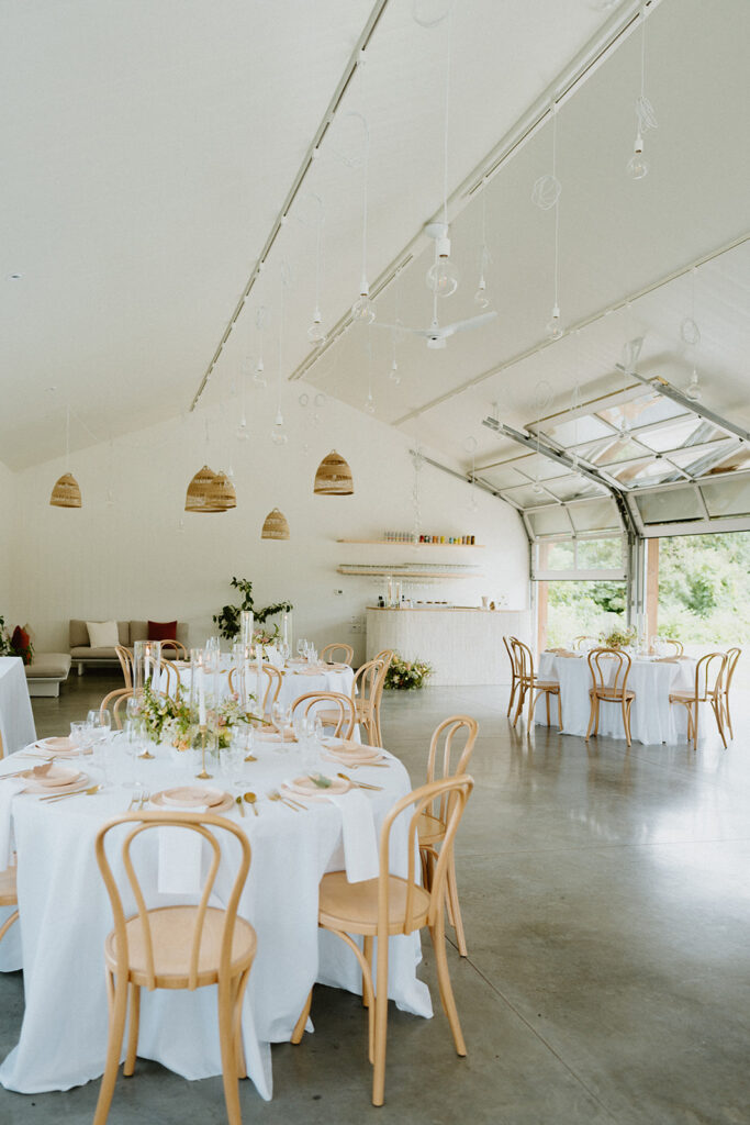 reception space at wedding venue set up with tables, chairs and decor